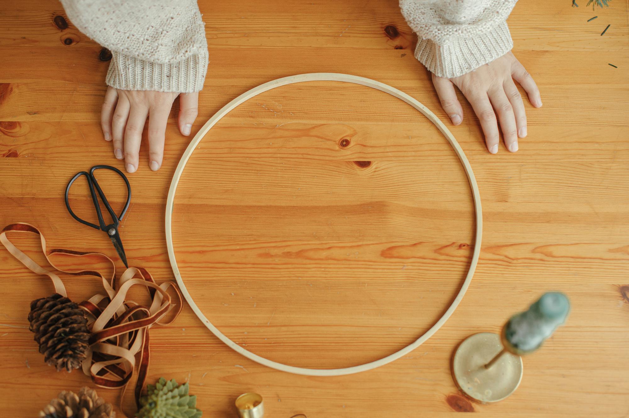 Hands working on embroidered hoop